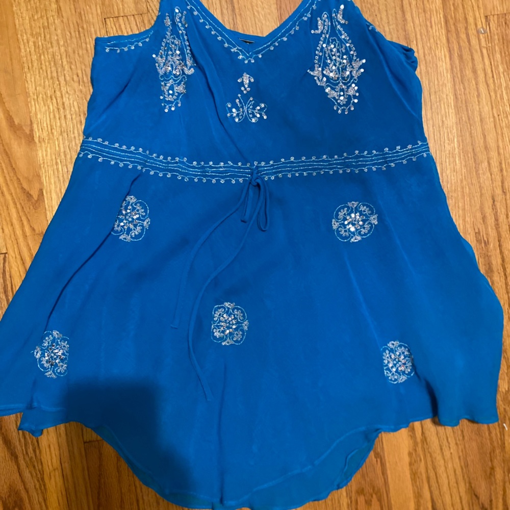 Women’s Size L , NWOT spaghetti strap Blue top with embellishment.